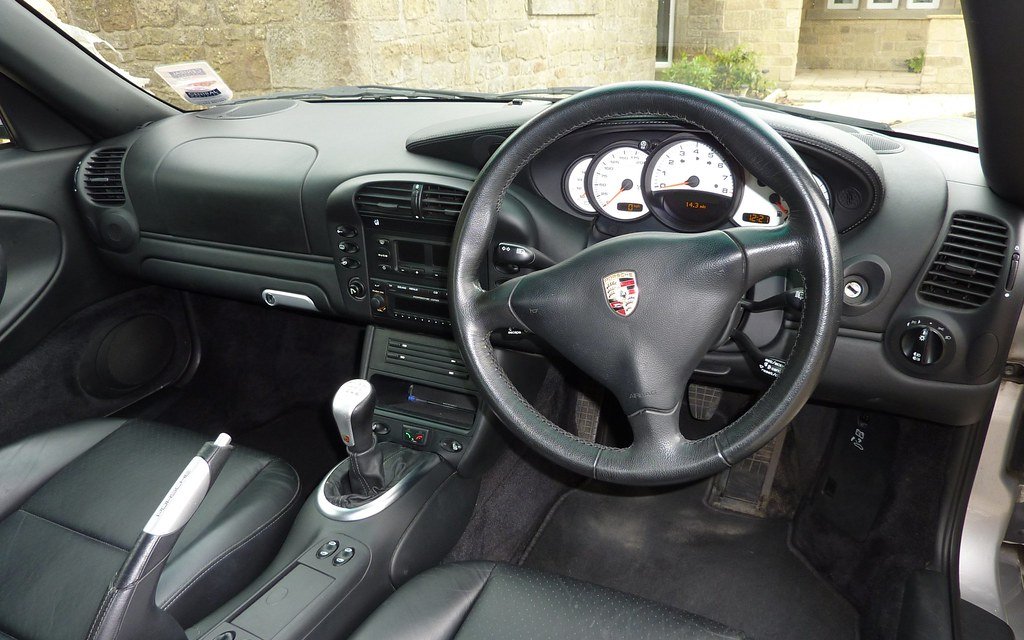 Clean, dust-free dashboard and steering wheel of a Porsche 911